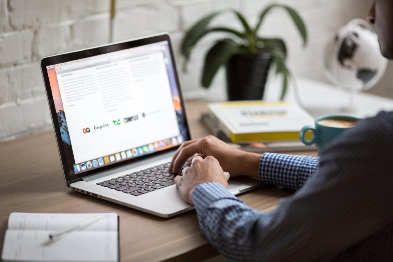 Engineer reviewing a web application on a laptop at a desk