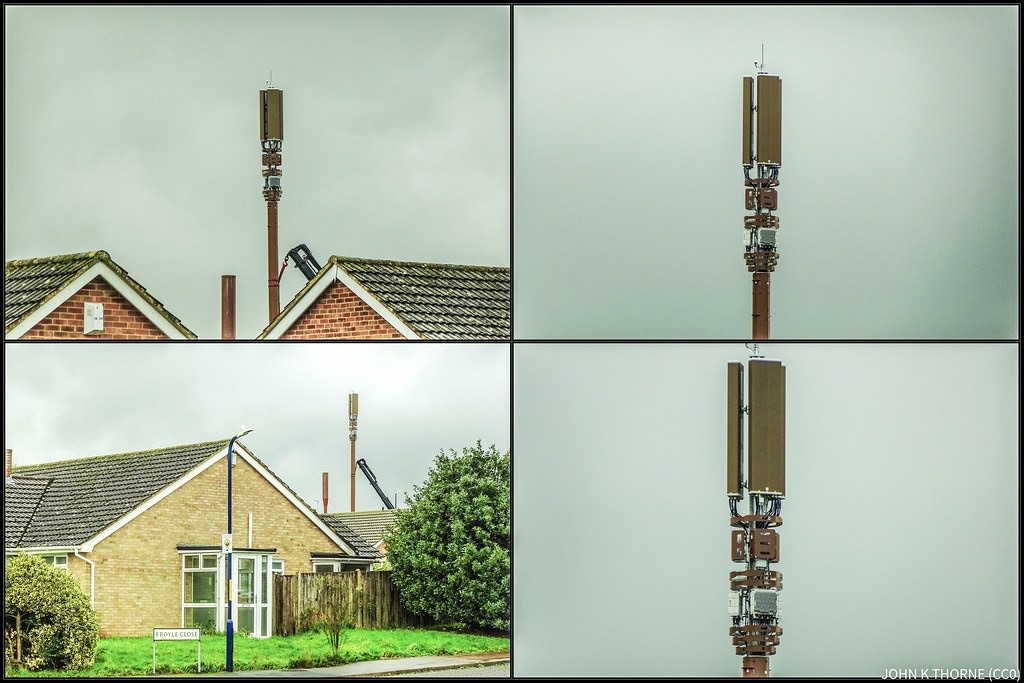 A 5G mobile phone mast with antenna panels rising above suburban rooftops
