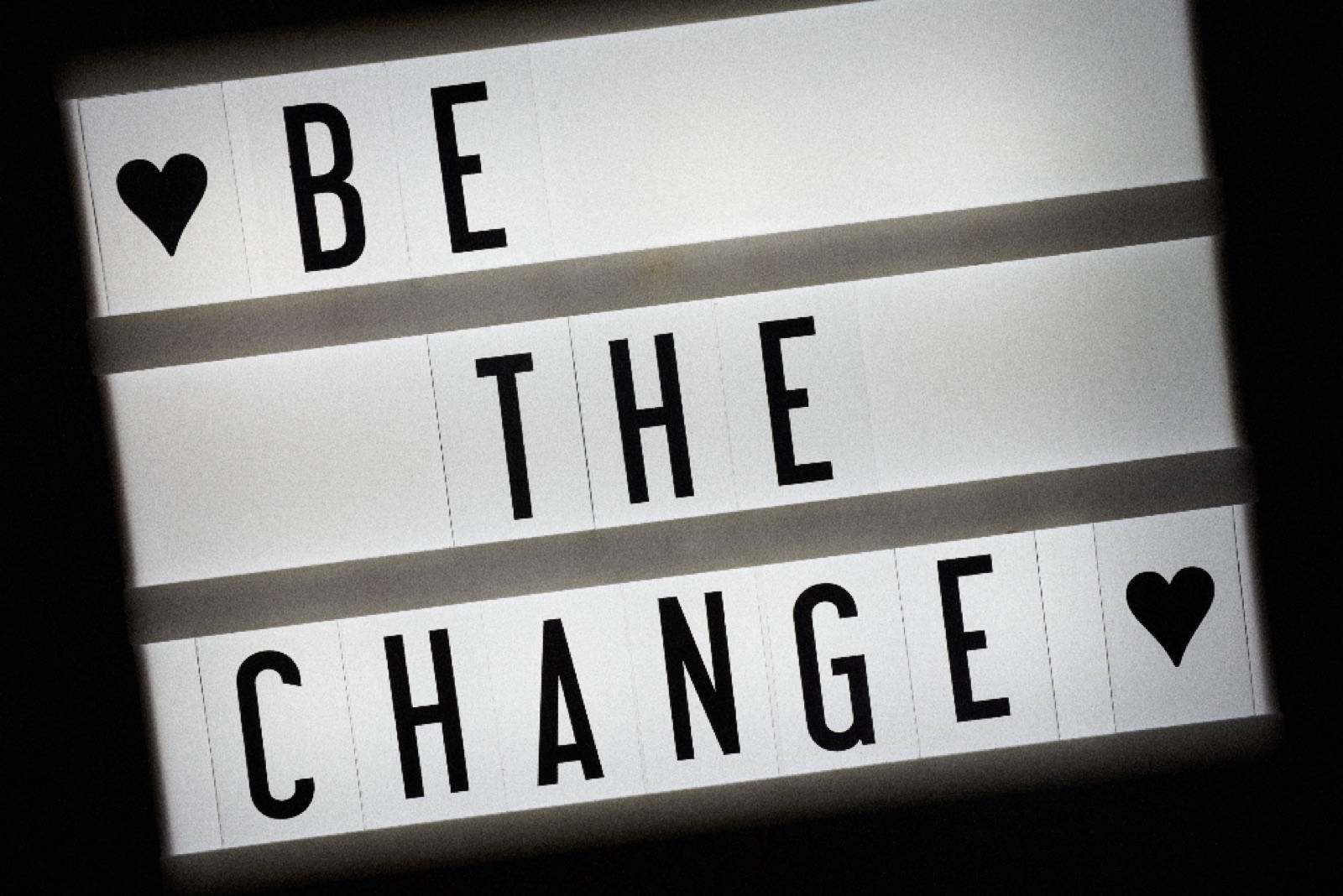 Lightbox sign reading Be the Change
