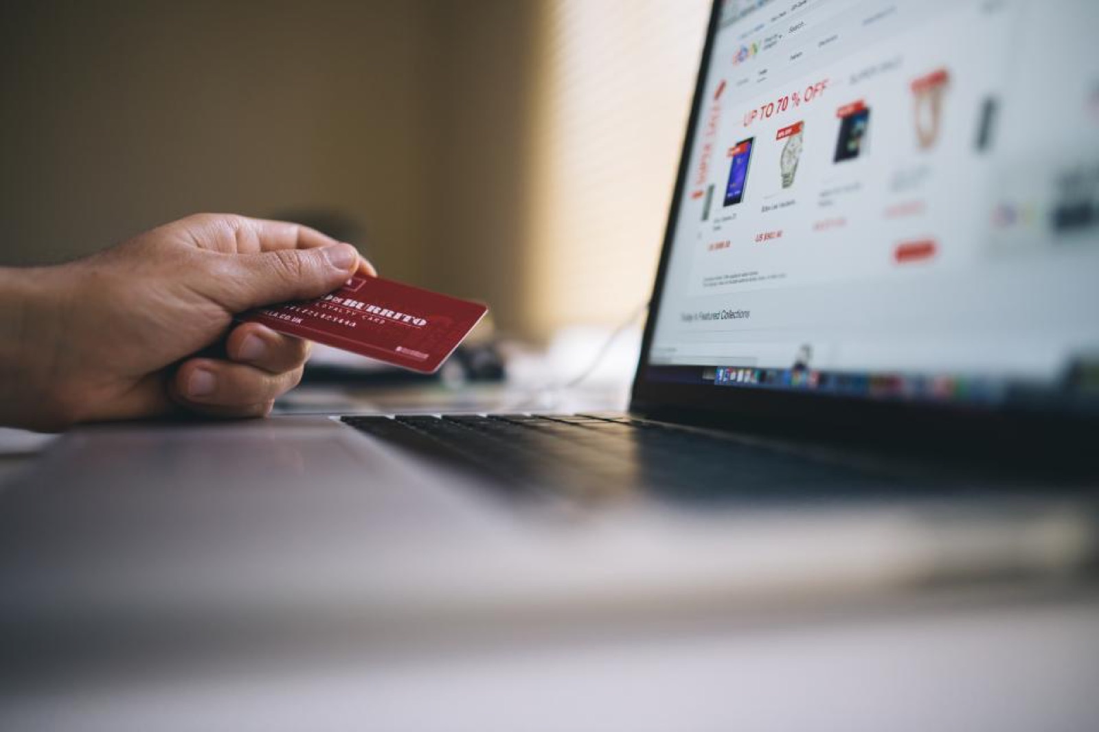 Customer paying with a card while shopping online on a laptop